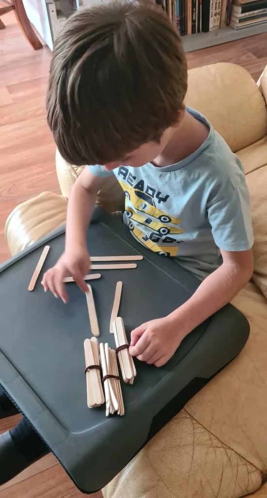 Kathy' son counting craft sticks