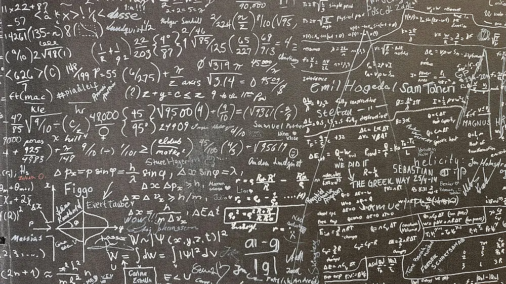 chalkboard full of complicated mathematical fornulas