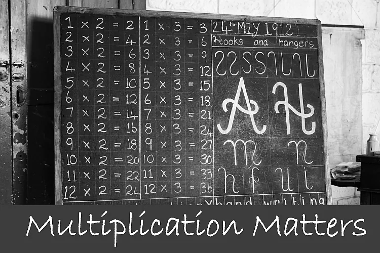 Chalk board with one and two times tables on it.